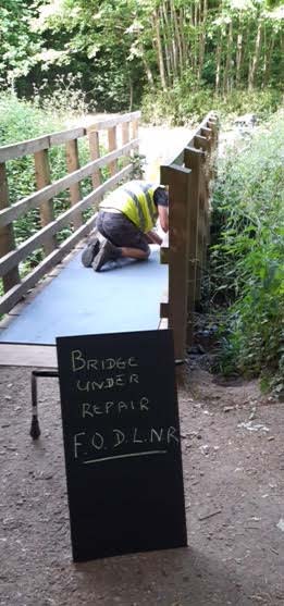 One of the Friends affixing the anti-slip surface to Dothill Bridge - June 2020.
